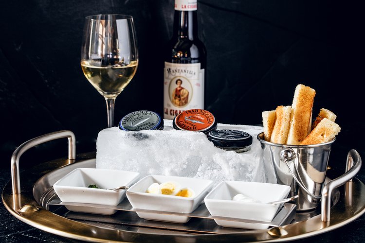 Manzanilla paired with their Tsar Nichoulai Caviar Service with brioche, quail egg, chives, and creme fraiche